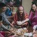 Hari Raya Malay grandmother, son and daughter in law serving food to the family at dining room