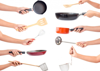 Chef's hands holding kitchen utensils/many equipment for food isolated on white background