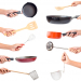 Chef's hands holding kitchen utensils/many equipment for food isolated on white background