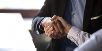 Close up african american businessman shaking hands with caucasian client. Handshake is symbol of starting finishing negotiations, successful teamwork signing contract, hiring human resource concept