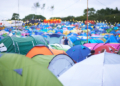 Shot of a campsite filled with many colorful tents at an outdoor festival