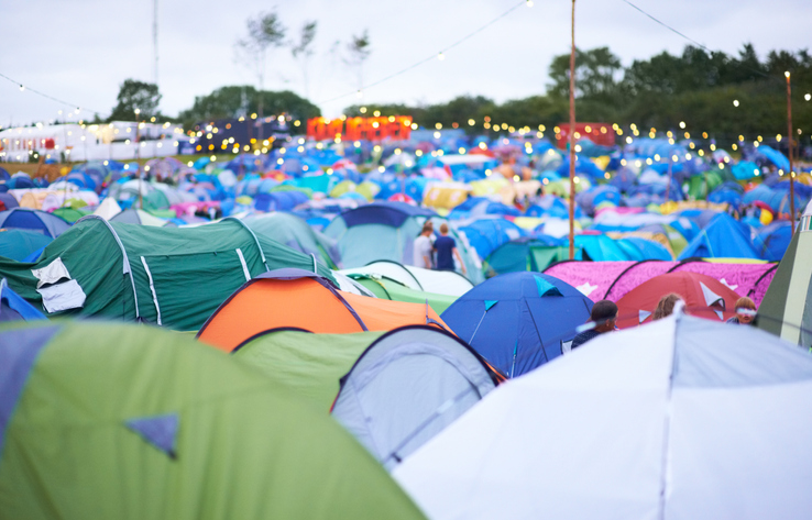 Shot of a campsite filled with many colorful tents at an outdoor festival
